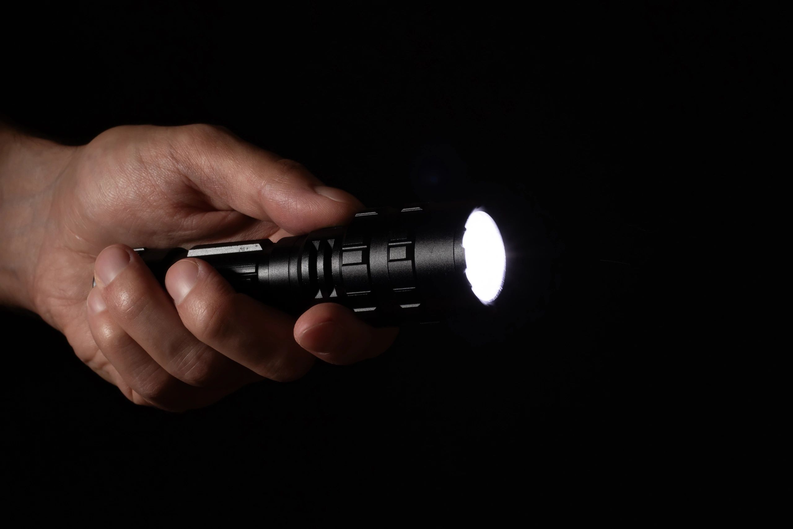 Hand holding a flashlight representing outage readiness